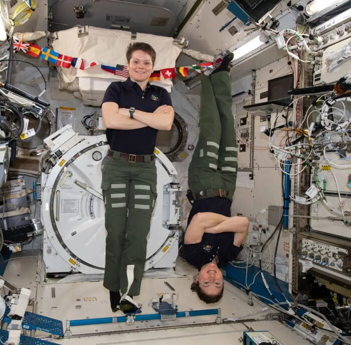 two women floating on a space station