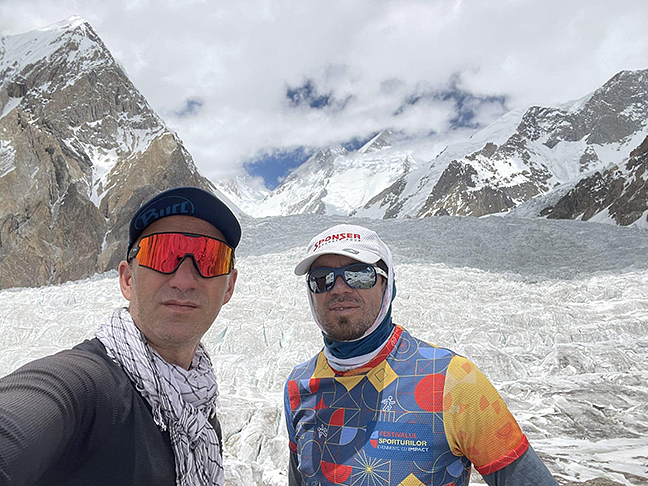 head and shoulders shot of two climbers against mountain background
