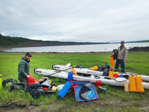 Simon Carrier and Maxime Geoffroy pack their kayaks on the Mackenzie River.