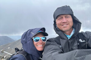 Andrew Hamilton and Andrea Sansone smiling in rain jackets