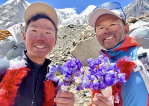 Kenro Nakajima, left, and Kazuya Hiraide with flowers after a past successful ascent