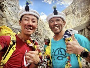 Two Japanese climbers ham it up after a successful summit