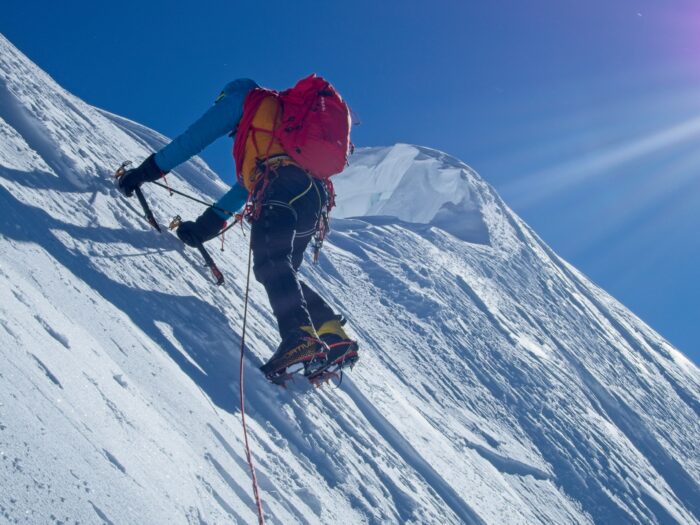 the climber on a sharp snow ridge