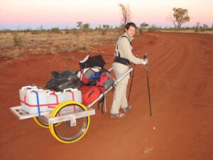 desert adventurer pulling a wheeled cart