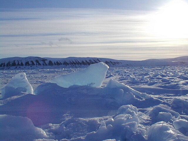 Sea ice with Edgeøya (Edge Island) rising in the background. 