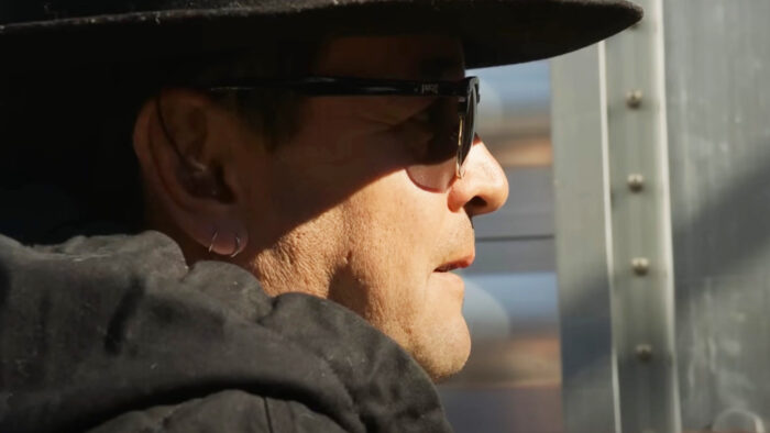 a man looking through a fence