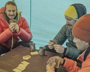 climbers playing cards in a tent