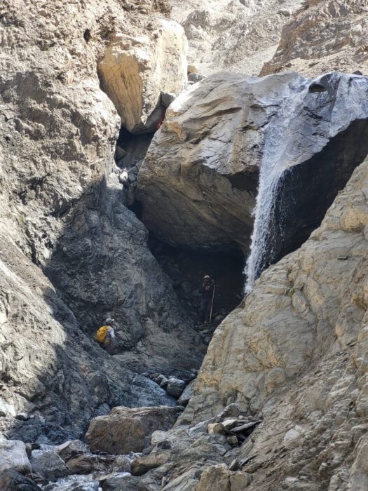 The climbers on a canyon with a little water but vertical sections. 