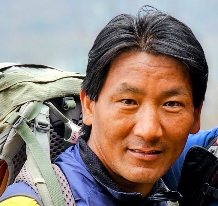 Close shot of Nawang Sherpa, carrying a backpack