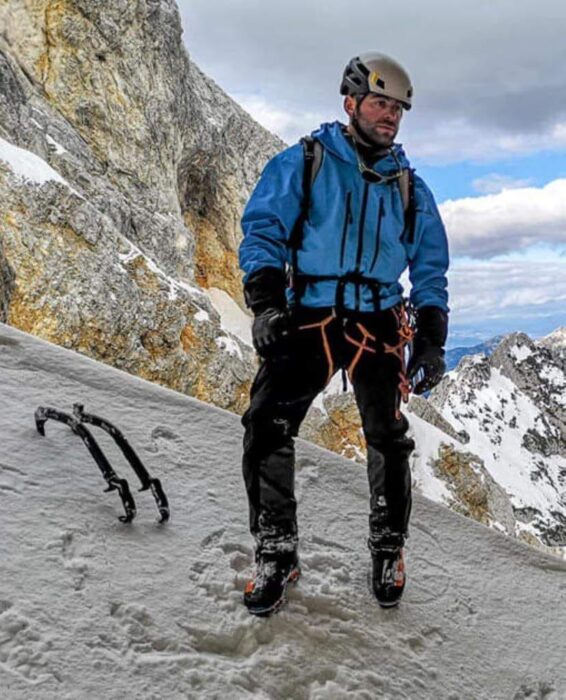 Badriashvili on an ice slope, his two iceaxes stuck on the ice at his feet. 