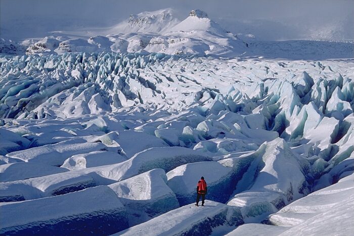 A person standing among crevasses on Breidamerkurjoekull glacier