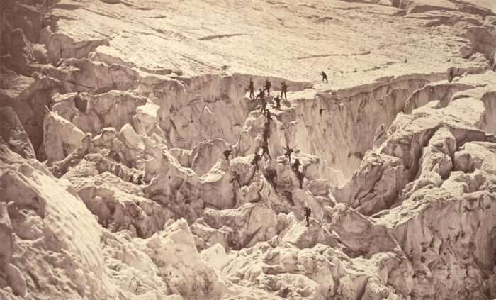 Very old image of a glaicer on Mont Blanc, with several people climbing up a serac