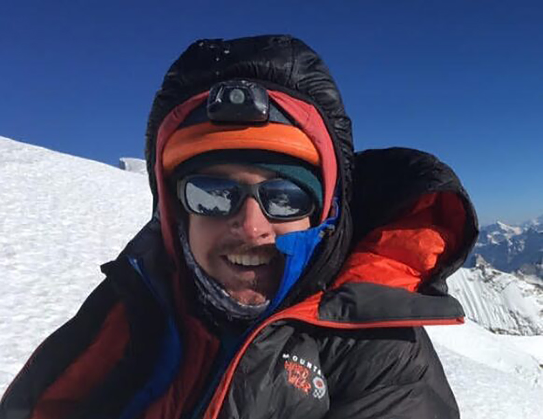 Close shot of Sam Hennessey with dawn jacket, helmet and sunglasses