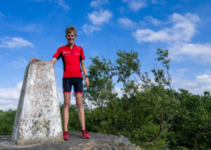 Alex Staniforth full length portrait in red shirt