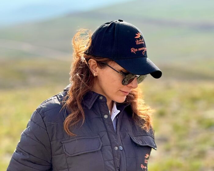 Close shot of Naila Kiani with baseball cap and sunglasses.