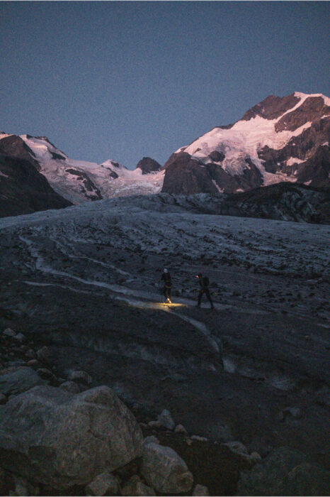 Kilian's headlamp shines on a glacier before the descent