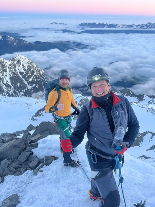 Climbers smile on a flat section at dawn