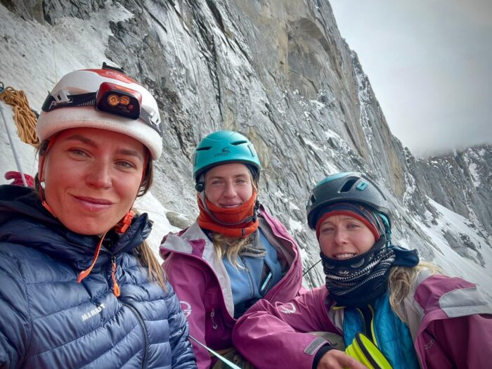 The climbers by the wall, in full climbing gear