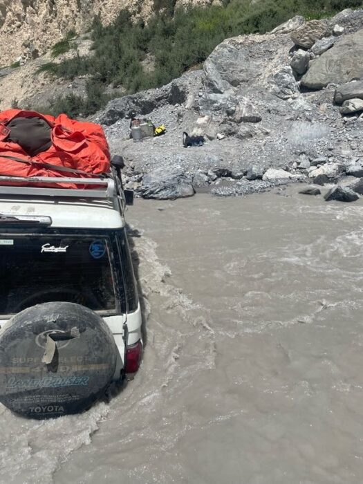 A 4x4 car sunk in muddy river waters