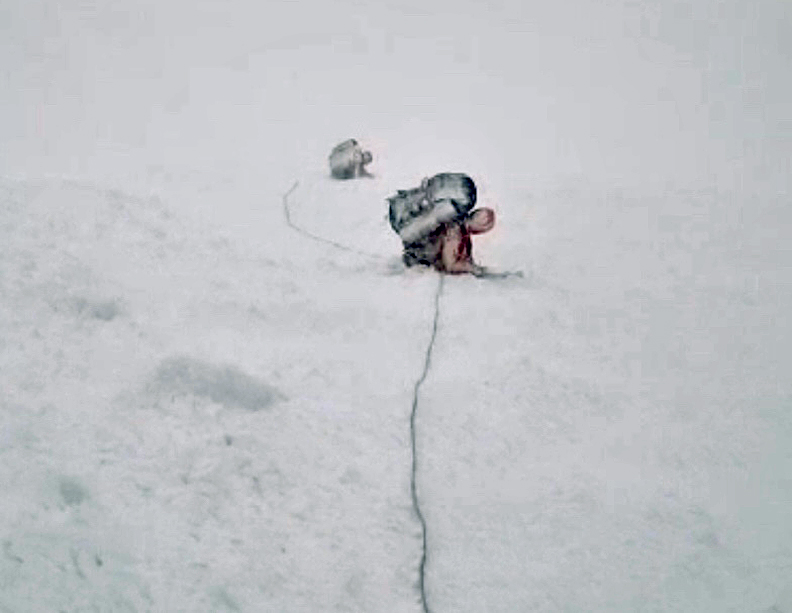 two climbers covered in snow dust