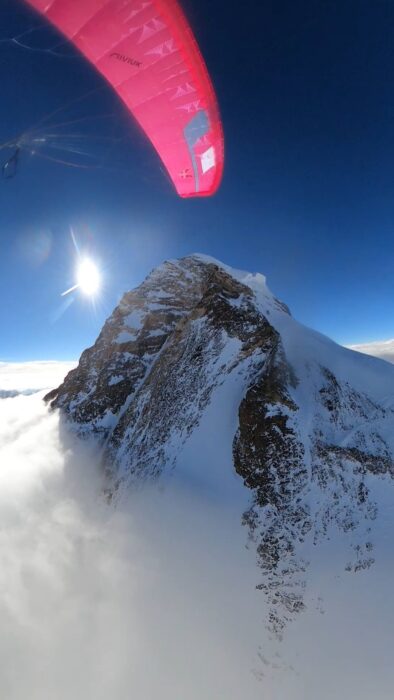 Upper slopes of K2 rising from a sea of clouds, as seen from a paraglide