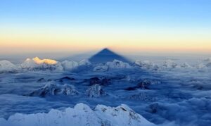 Everest cast its shadow on surrounding peaks and clouds