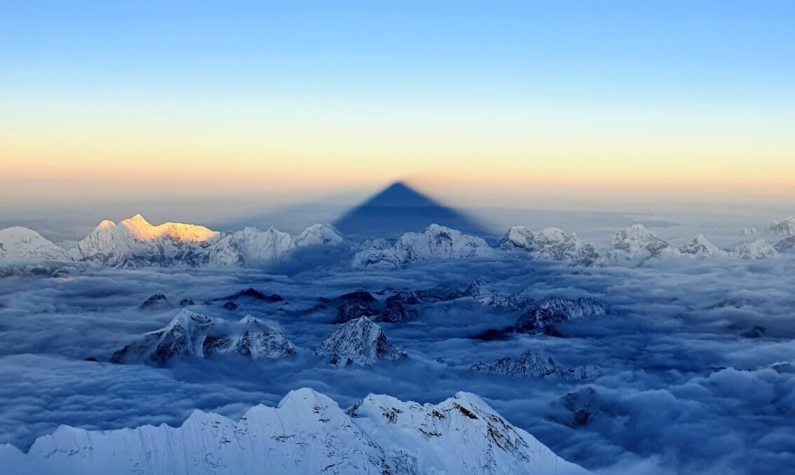 Everest cast its shadow on surrounding peaks and clouds