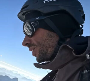 CLose shot of Jornet with helmet, sunglasses and a tired-looking face