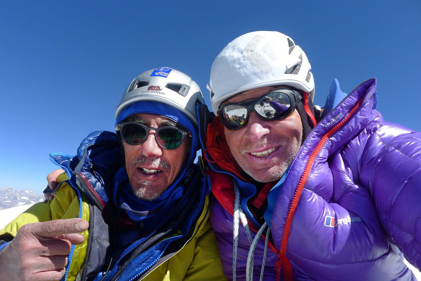 Close shot of the climbers with helmets and high mountaineering outfit.