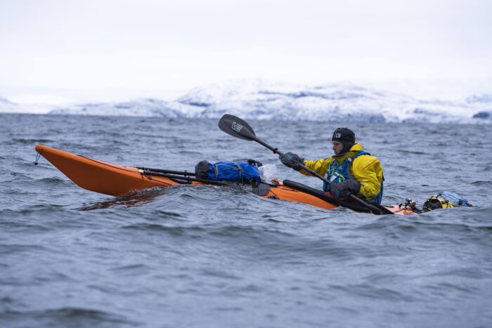 kayaker in rough arctic waters, side on