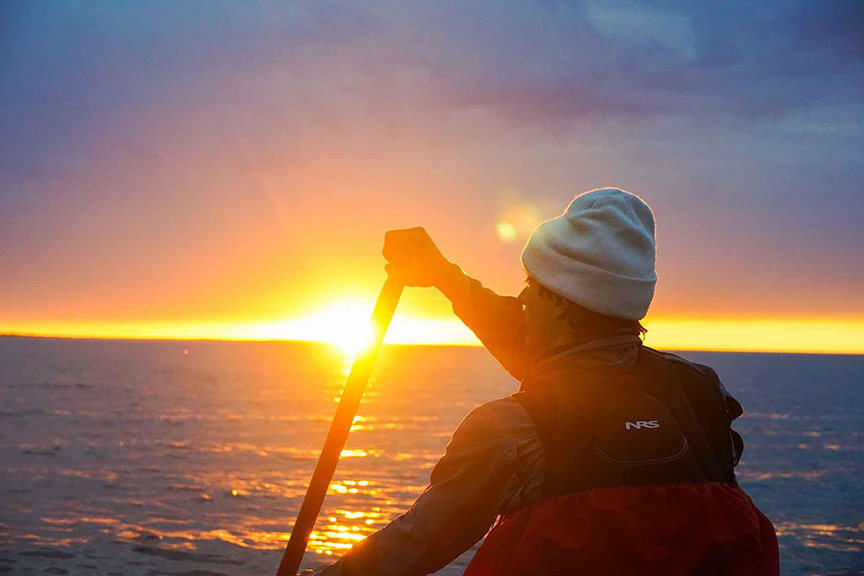 bow canoeist at sunset