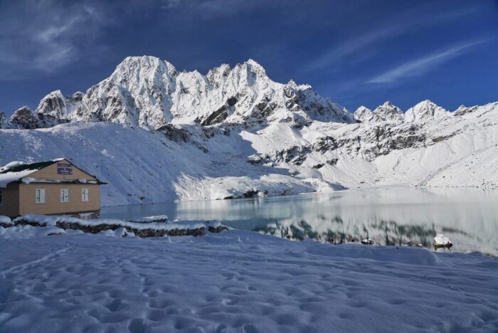 One of Gokyo Lakes with all surroundings covered in snow. 