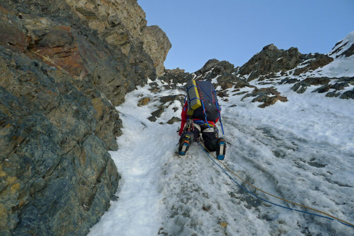 Mick Fowler as seen from below on a vertical section of iced up rock