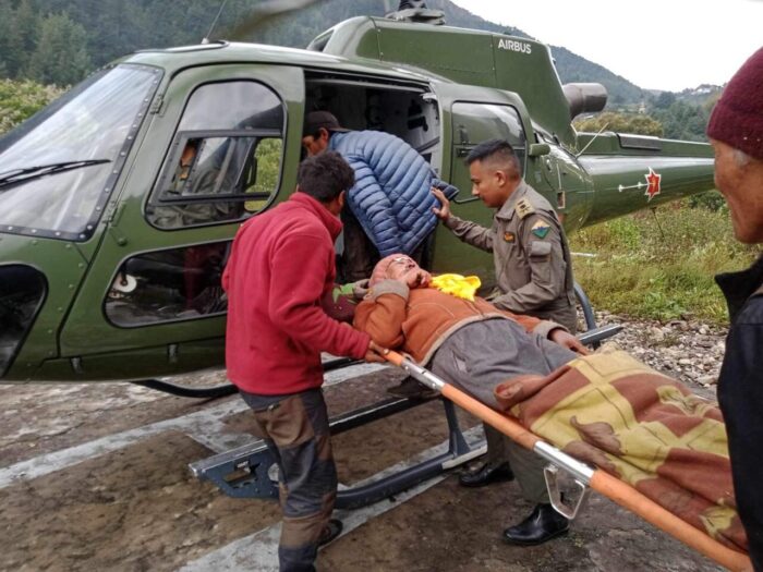 A man is taken to a helicopter in a stretcher