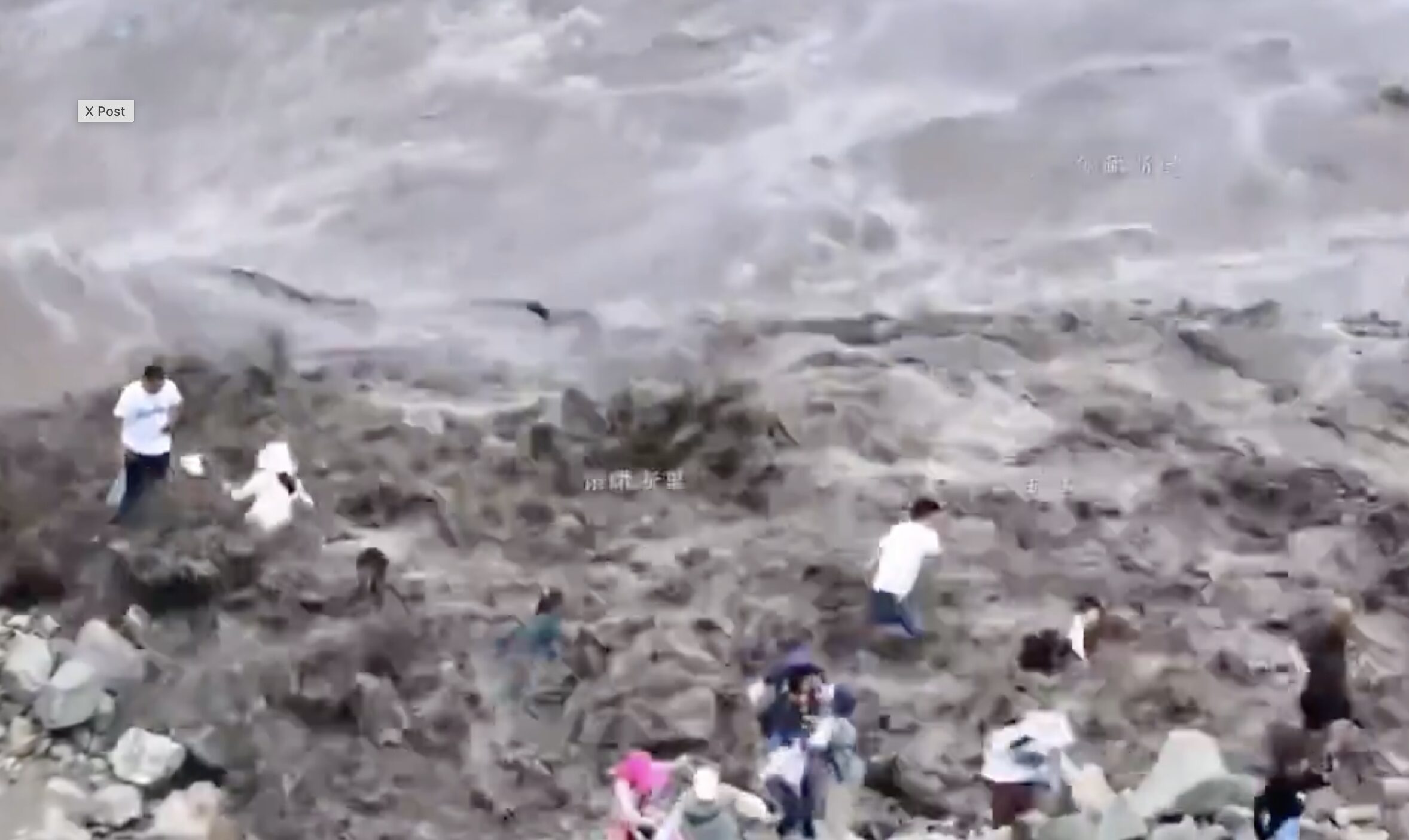 A screenshot of the tidal bore catching the tourists.