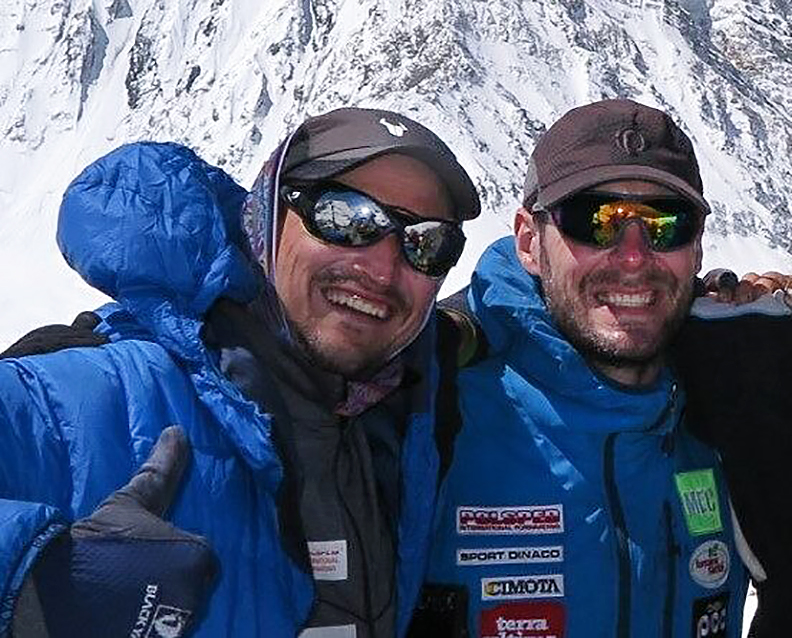 The climbers smile in mountain gear, Bielecki gives a thumbs-up