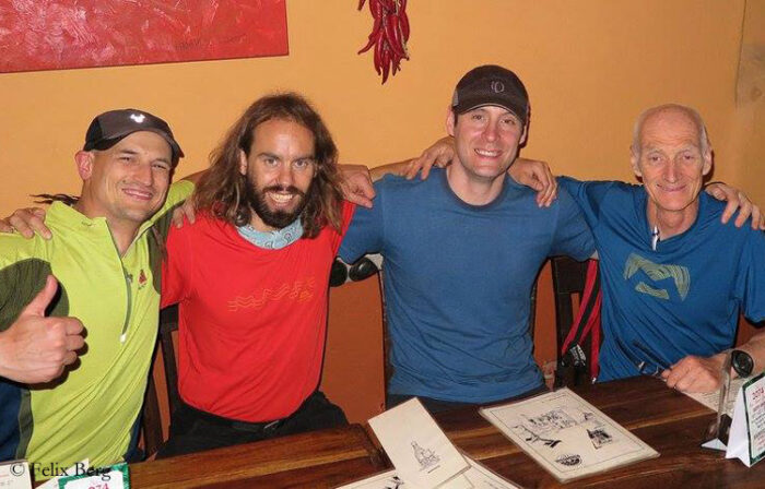 The climbers shoulder to shoulder behind a table