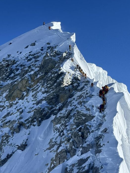 Climbers on Hillary Step on everest in a sunny day