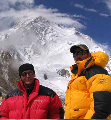 The Kazakhs smile with heavy dawn jackets and K2 behind them