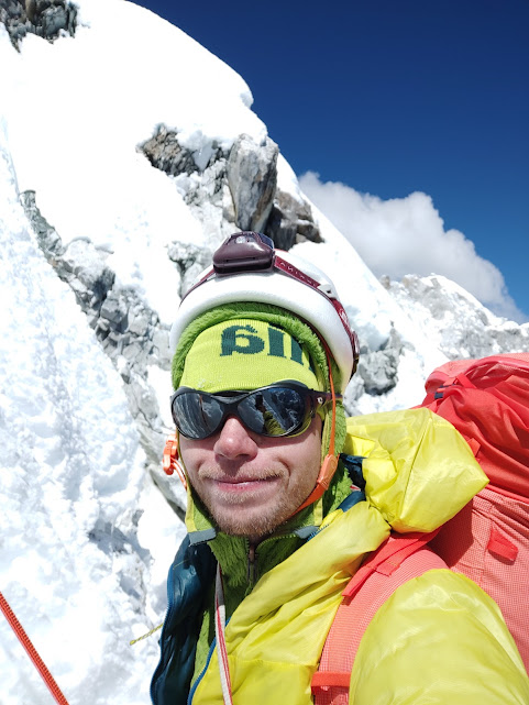 Close shot of the climber while belaying on a snowy ramp