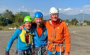 the climbers with gear and helmets still on at an aerport