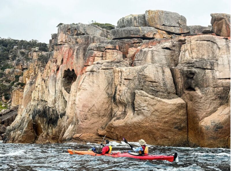 Kayaking past Shouten Island’s rugged granite cliffs.