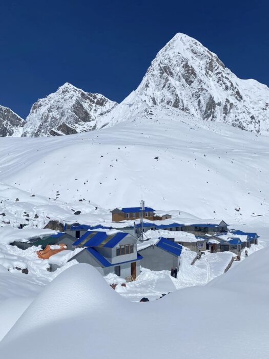 Lodges semi covered in snow. Pumori in Background, Gorak Shep