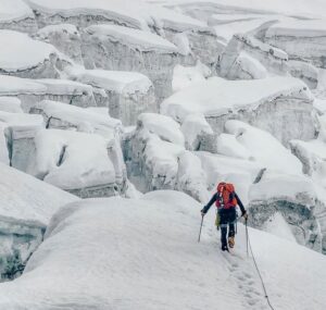 Crossing the crevassed glacier to the head of the southeastern wall of the unclimbed Atta'niz Sar in the Hunza Valley.