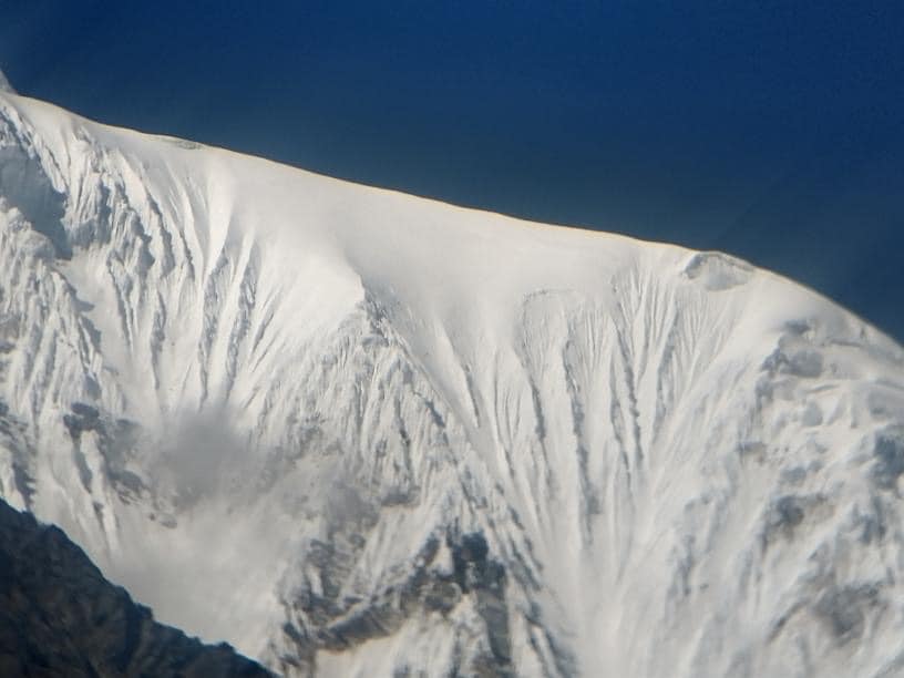 The snowy summit ridge of Langtang Lirung as seem from Ghompa village