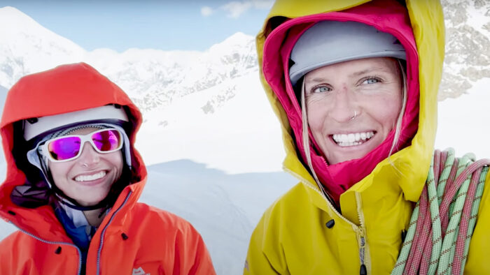 two women smile at the camera