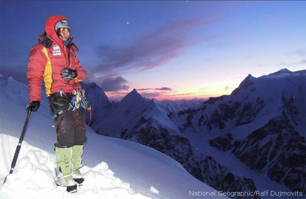 Kaltenbrunner looks to the mountains around at sunset from a snowy slope