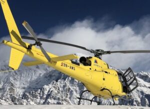 A yellow helicopter on a mountain area