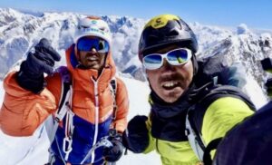 The climbers smile on the summit of Tirich Mir.