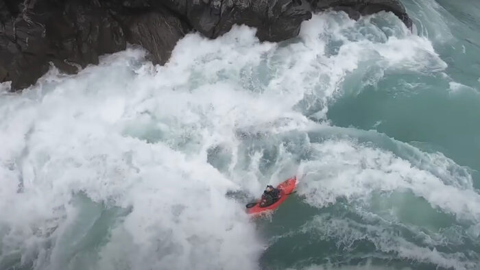 a kayaker runs a rapid